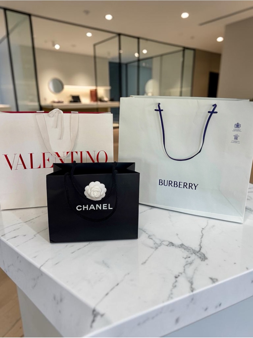 Set of Three Designer Shopping Bags Including Chanel with Camelia